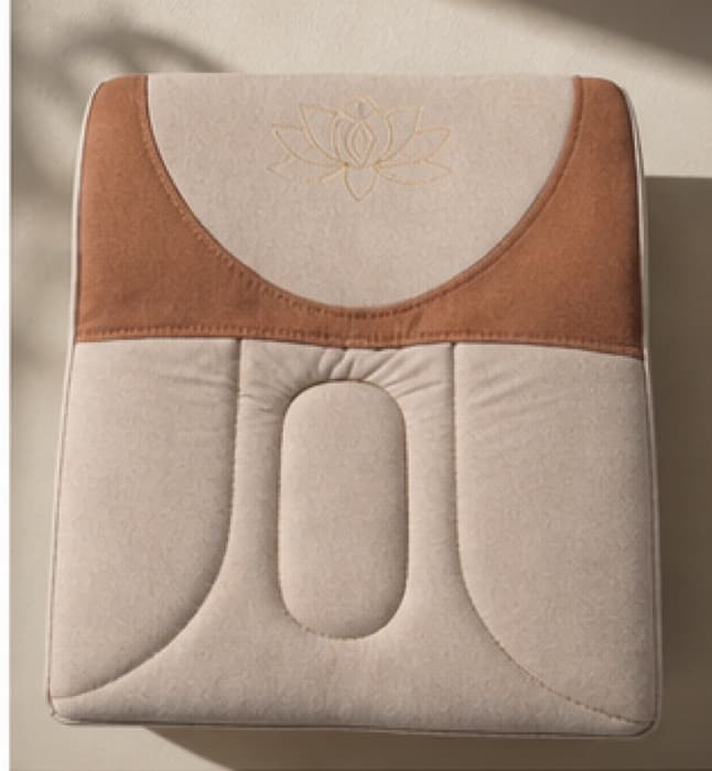 Top view of the seat, the sculpted oval relief channel visible at the centre of the quilted cover