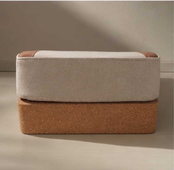 The cushion lifted clear of its cork tray, showing the full depth of the latex base beneath the cover